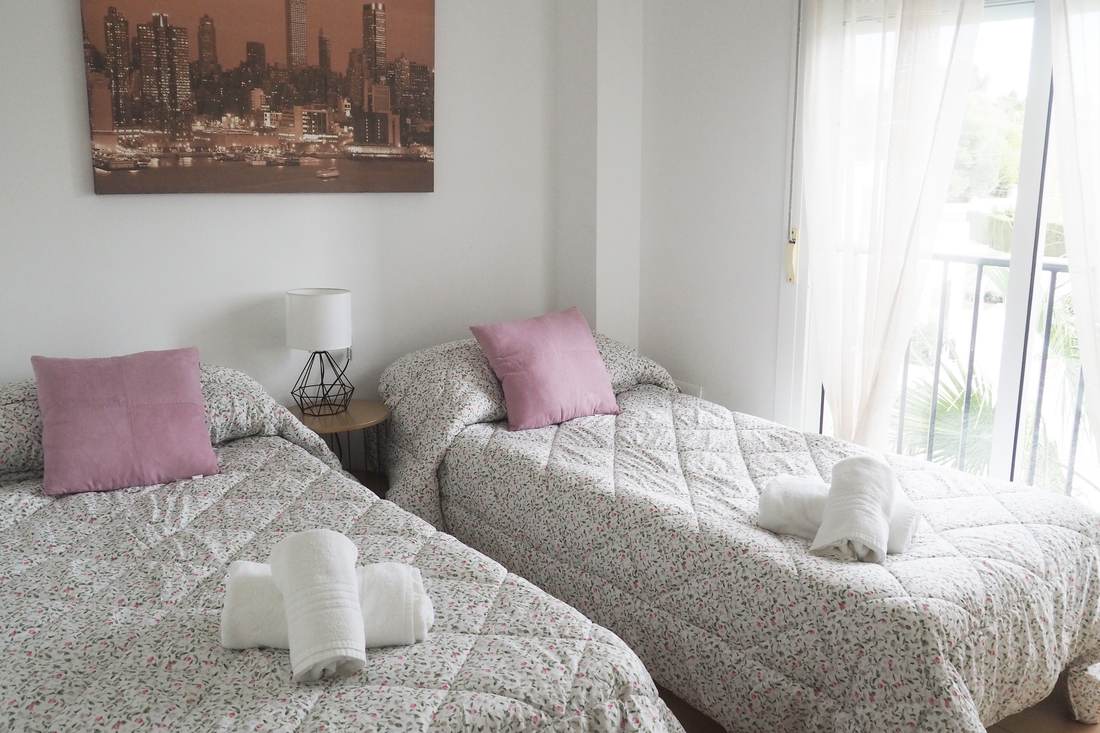 Bedroom with two single beds and flowered bedspreads