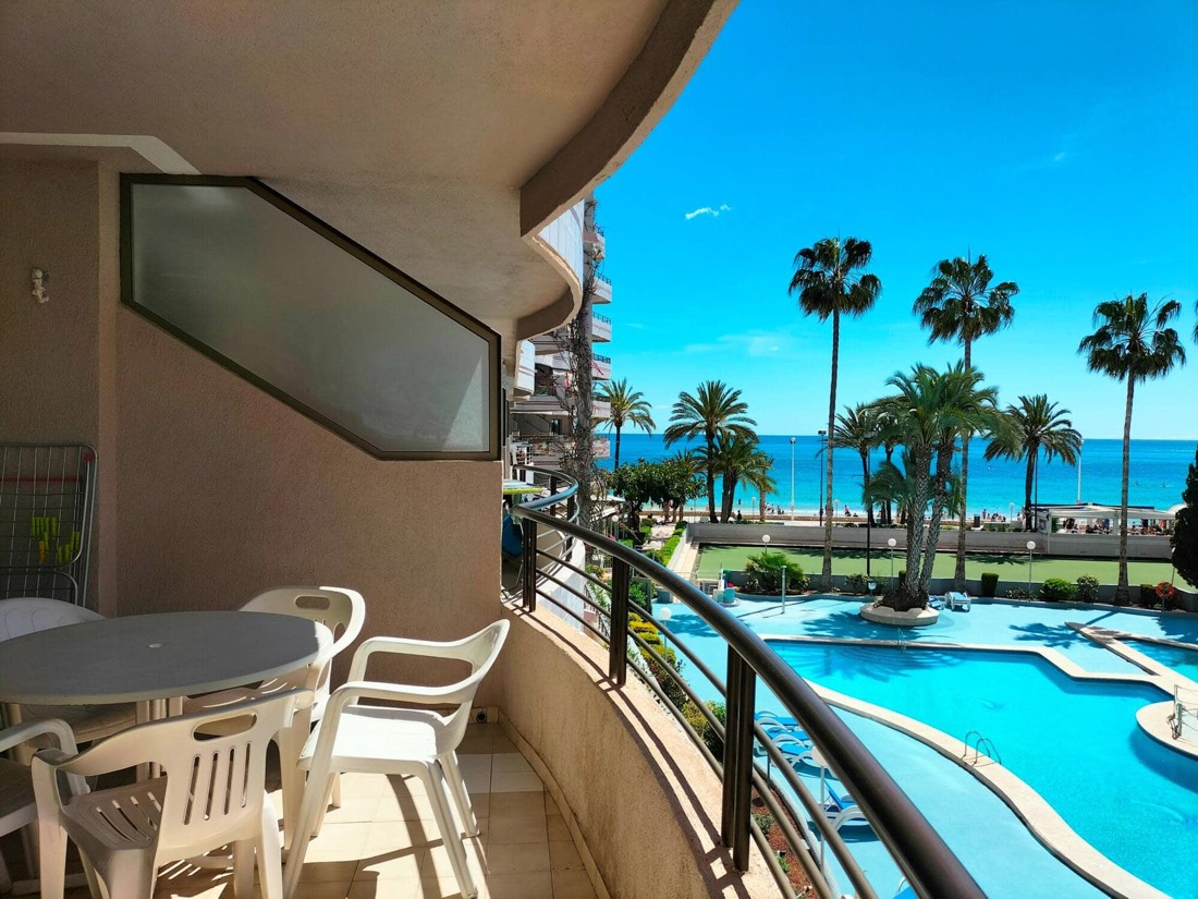 Corner of the terrace with a table, looking at the pool