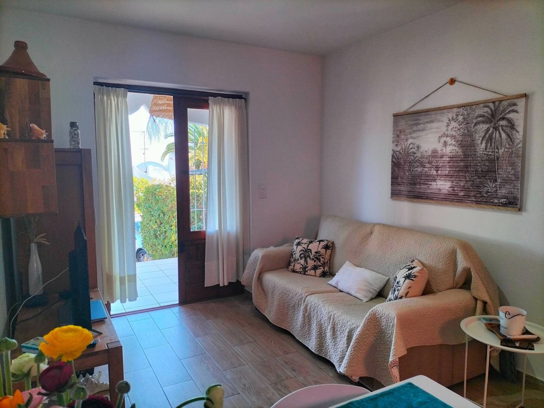 Living room with a sofa and the door open to the terrace