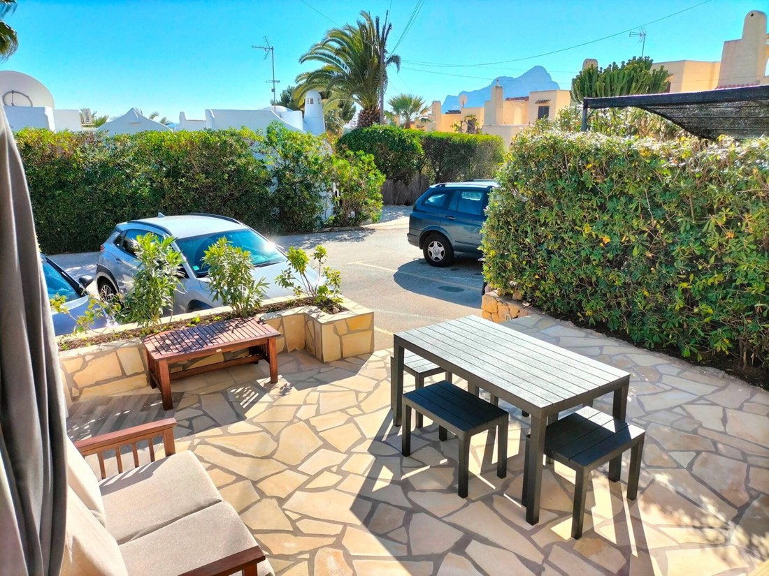 Terrace with an outdoor table and parking right in front