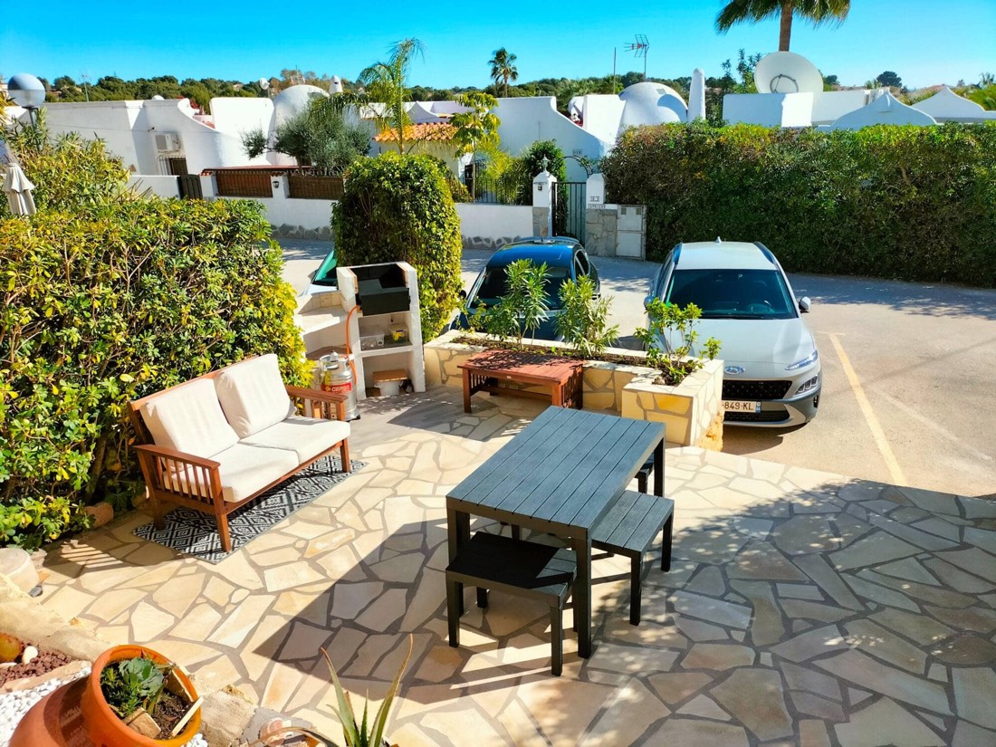 Front terrace with an outdoor sofa, table and barbecue