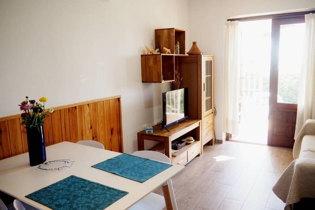 Dining area with wooden furniture and a TV