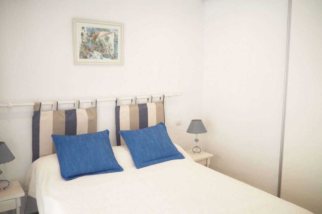 Main bedroom with a double bed and blue cushions