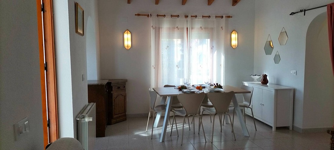 The dining room at Casa Margarita with the table laid by the big window