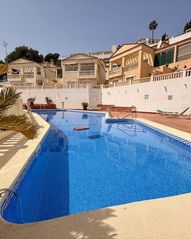 The communal pool at Costa Rica with the terraced houses behind