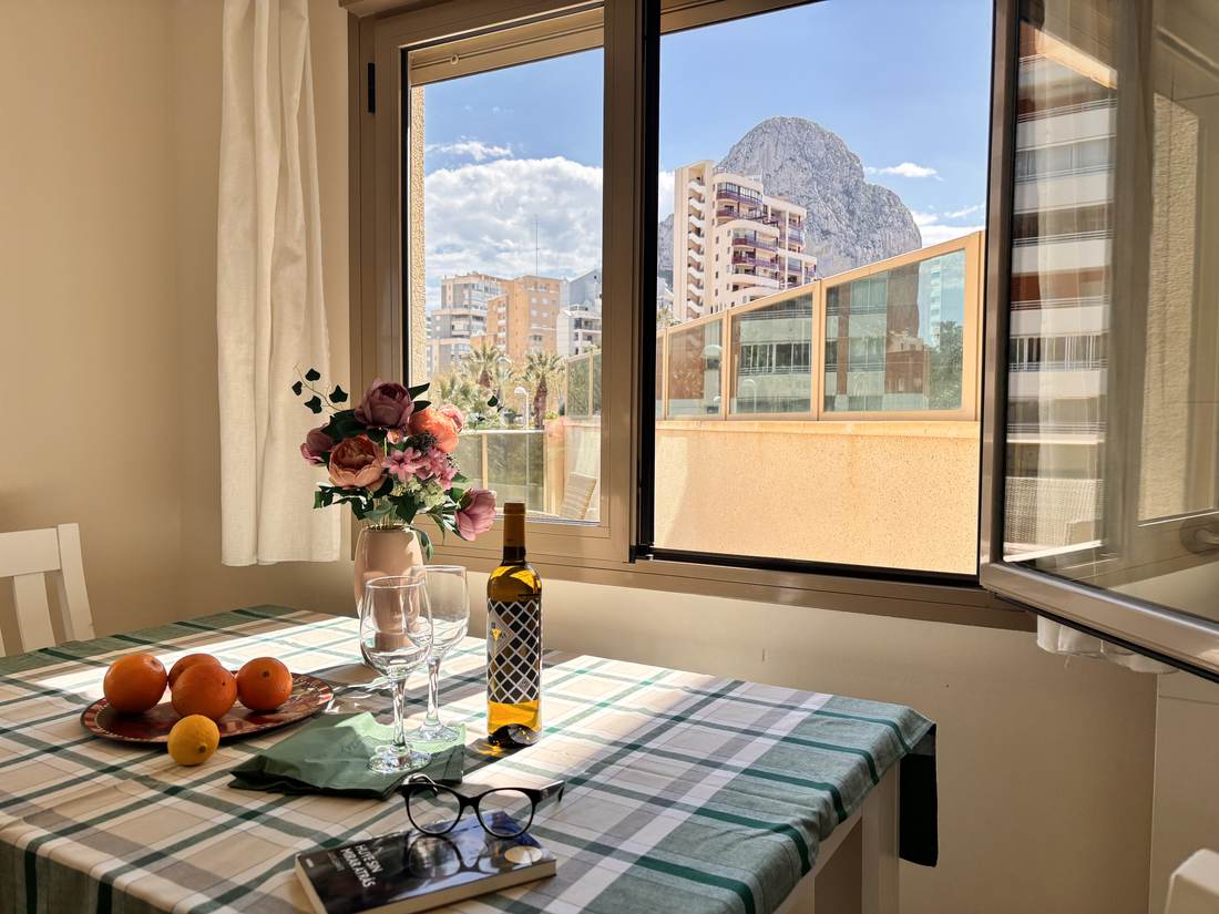 Dining area by the big window, with the Peñón de Ifach behind