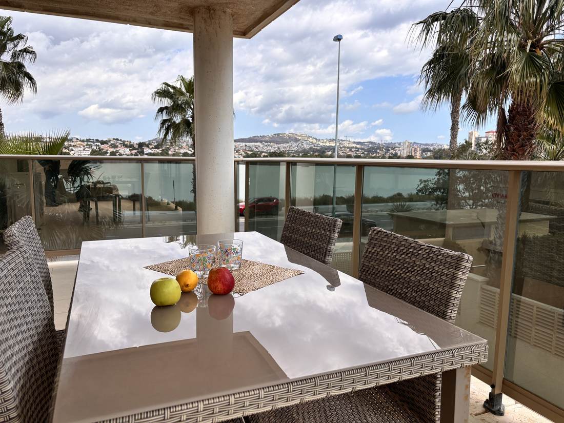 Table laid on the terrace, with fruit and the view