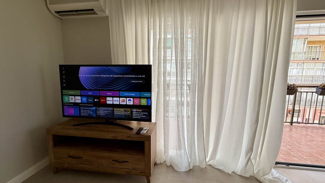 The living room with the TV and the big window onto the terrace