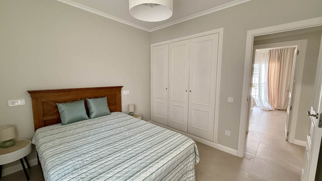 Bedroom with a double bed and wooden headboard