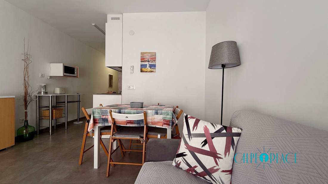 Dining area with a light wooden table and four chairs