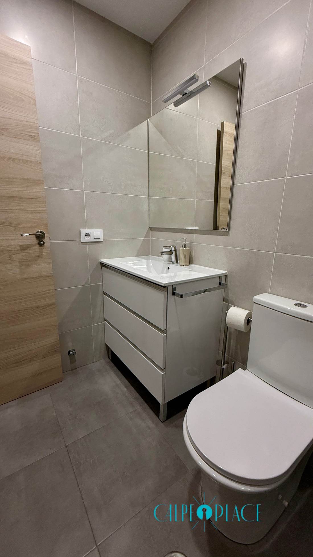 Refurbished bathroom with vanity unit and mirror
