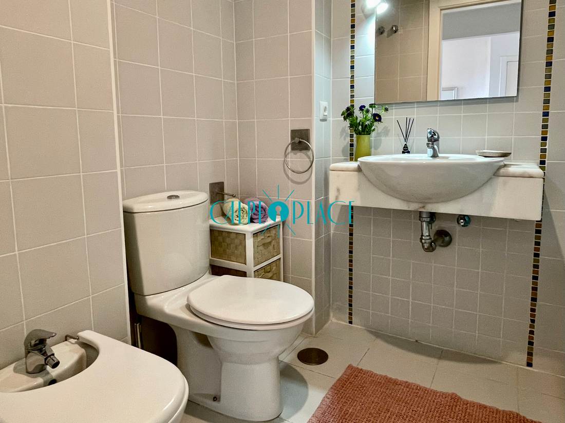 Baño completo con lavabo, inodoro y espejo