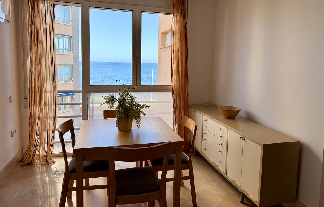 Dining corner by the gallery, with the sea on the other side of the glass
