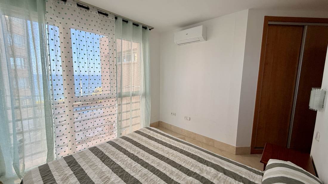 The bedroom from the other side, with the floor-length curtains