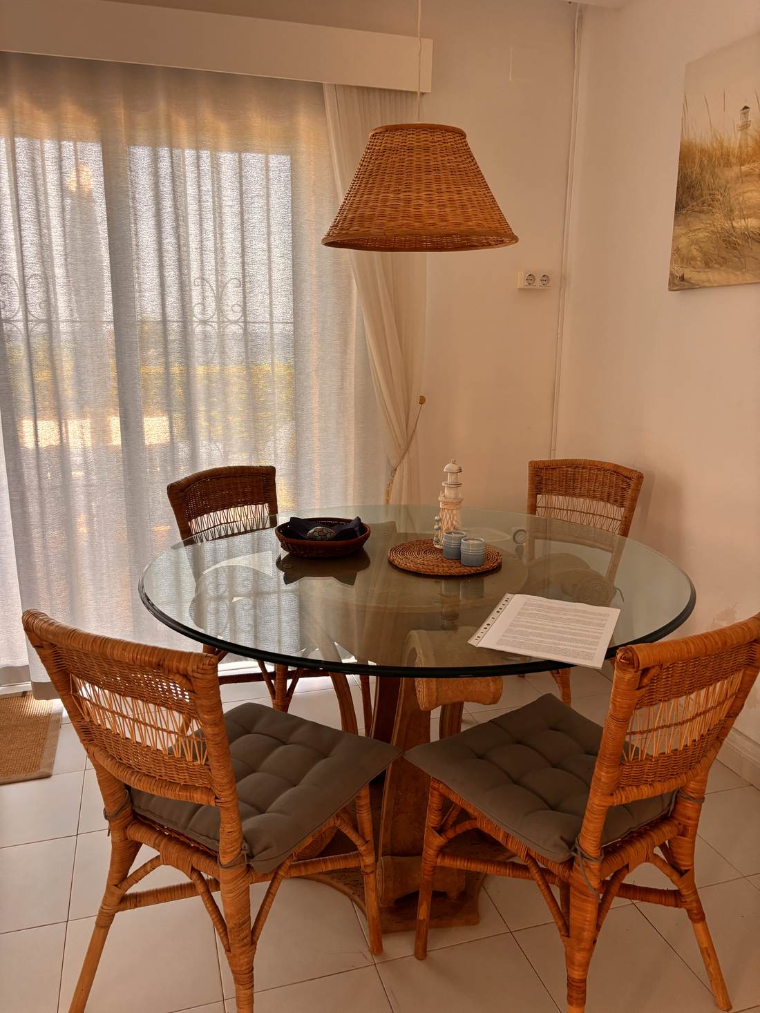 Comedor con mesa redonda de cristal junto a la ventana