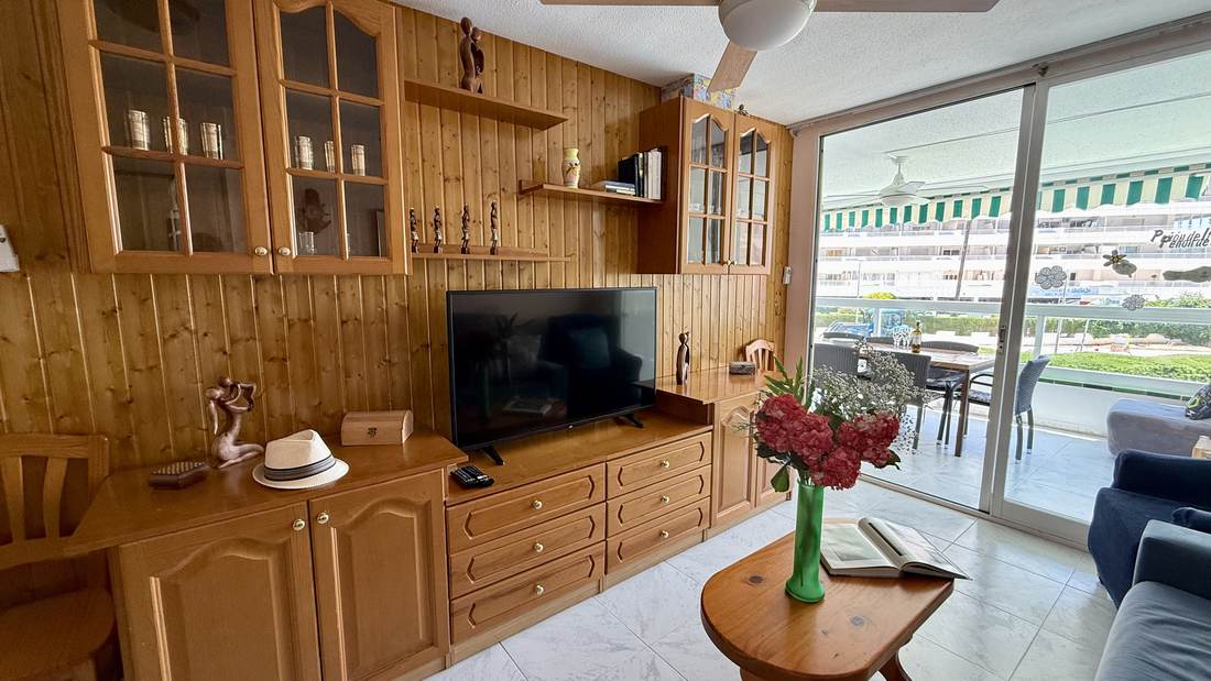 Living room with the glazed gallery open to the pool and the sea