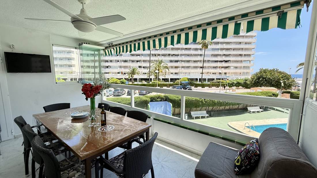 Dining table in the gallery, with the pool and the beach behind