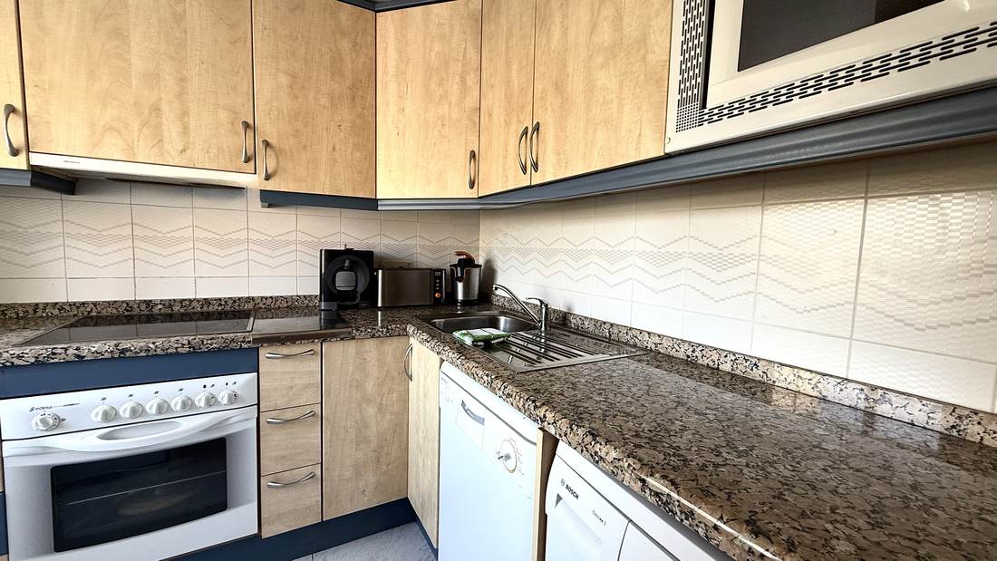 Separate kitchen with granite worktop and oven
