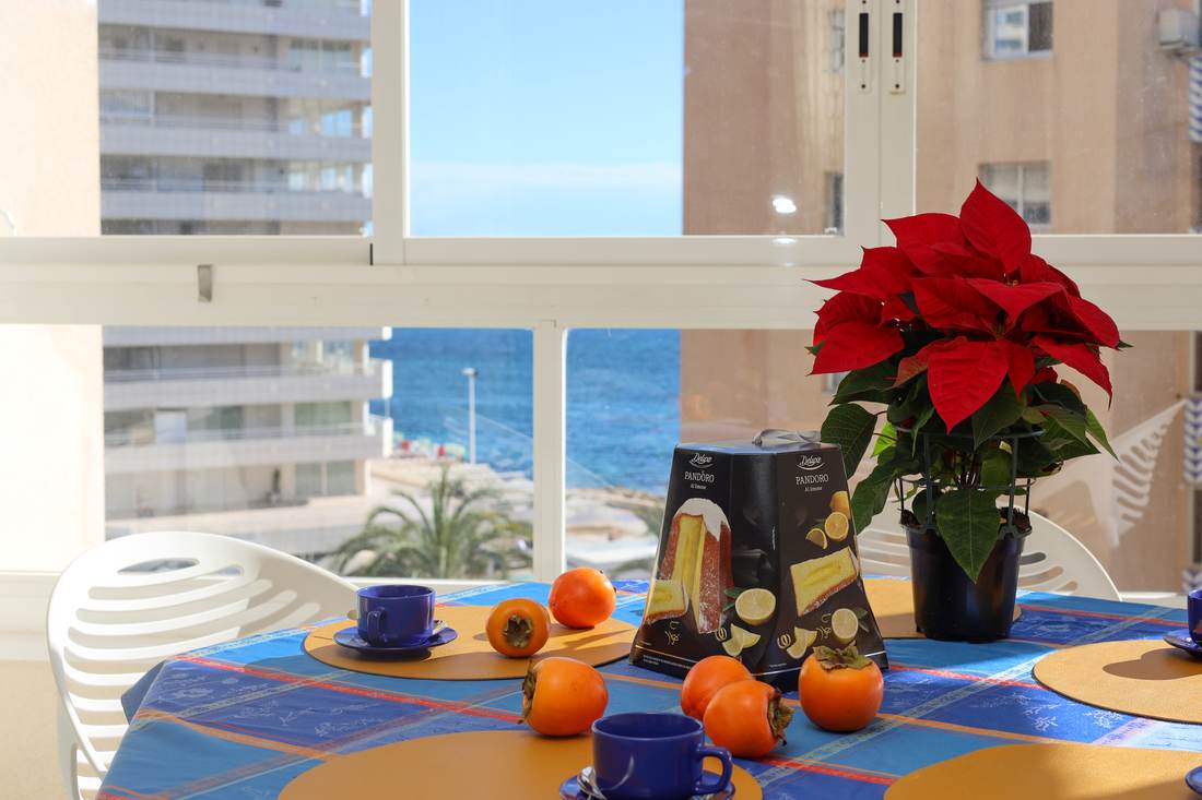 Dining table by the big window, with the sea beyond