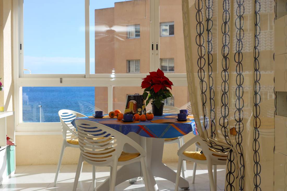 Gallery with a table and chairs and views over the bay