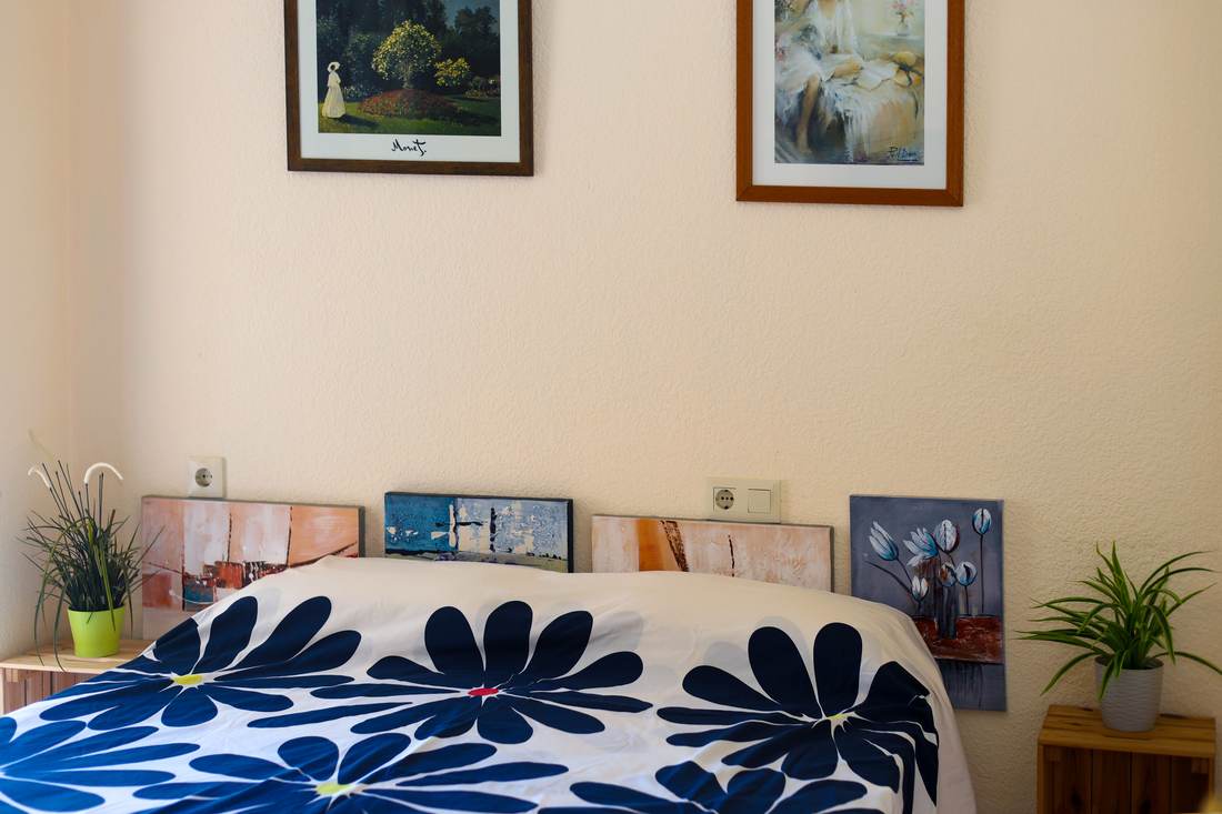 Bedroom with a blue flowered bedspread
