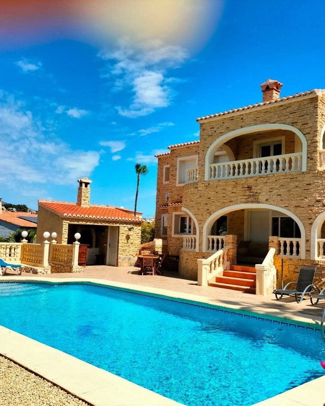 The pool at Villa Los Almendros in front of the arched stone façade