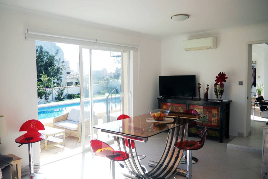 Comedor con mesa de cristal y salida directa a la piscina