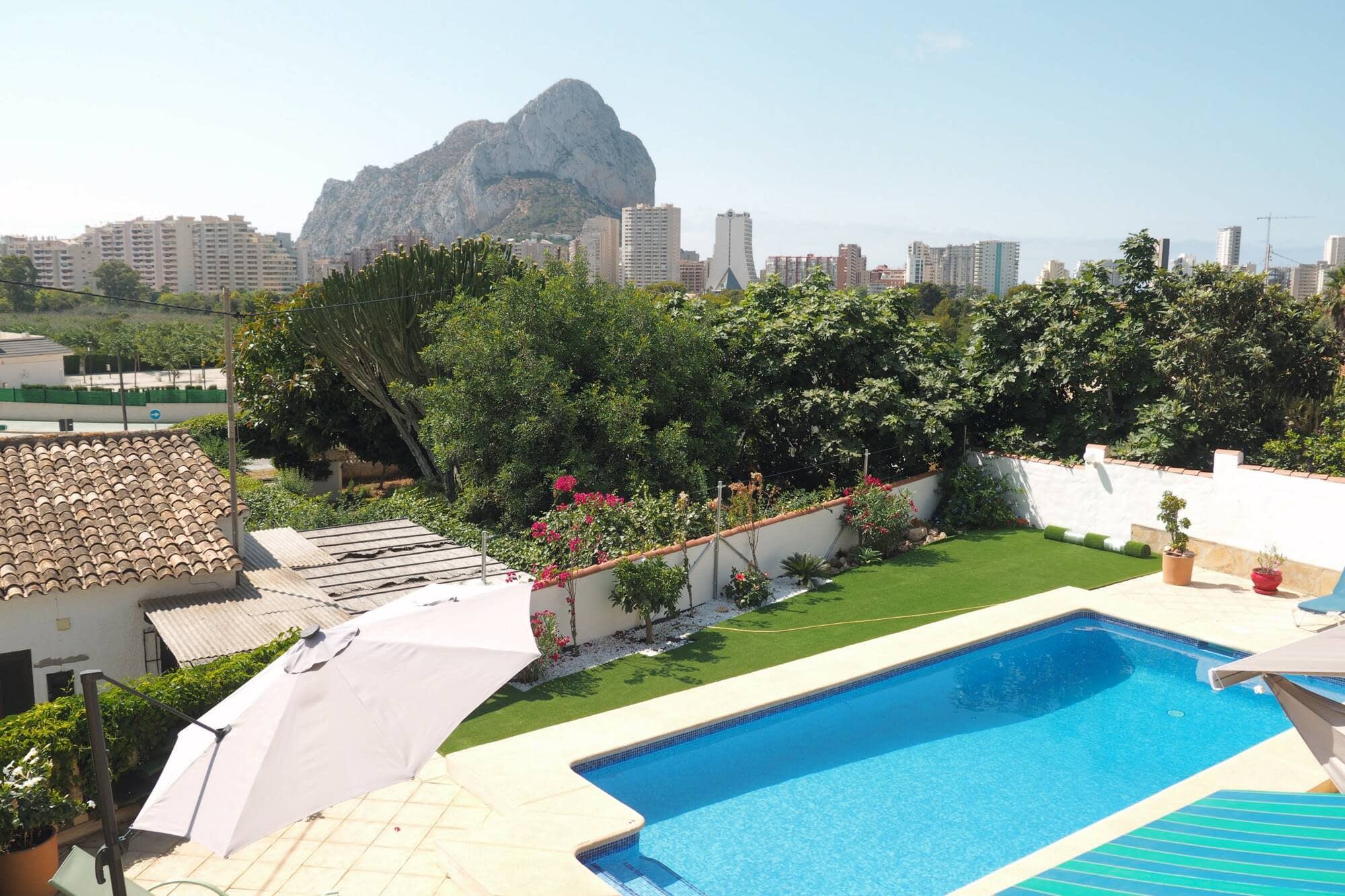 The garden and pool at Villa Yasmin with the Peñón de Ifach and Calpe behind